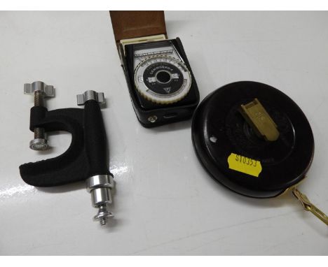 Trickle Measuring Tape, Photographic Light Metre and a Clamp 