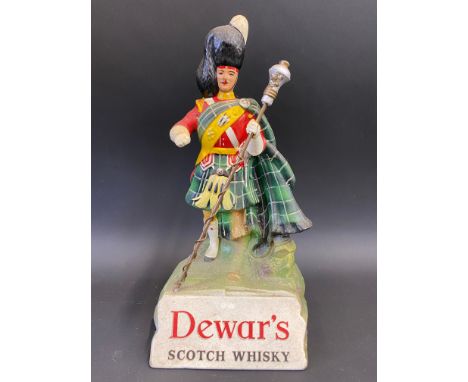 A Dewar's Scotch Whisky advertising figure, 9 1/2" h.