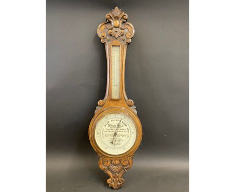 An early 20th Century oak cased barometer with advertising to the dial for Harry Hall Coat Breeches Habit and Costume Special