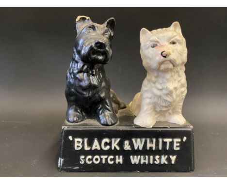 A Buchanan's 'Black &amp; White' Scotch Whisky advertising figure of two dogs, 5 1/2" w.