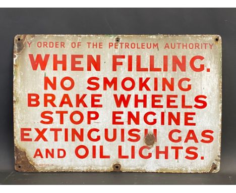 An early Petroleum Authority garage forecourt enamel sign featuring instructions to extinguish Gas and Oil Lights, 21 x 14".