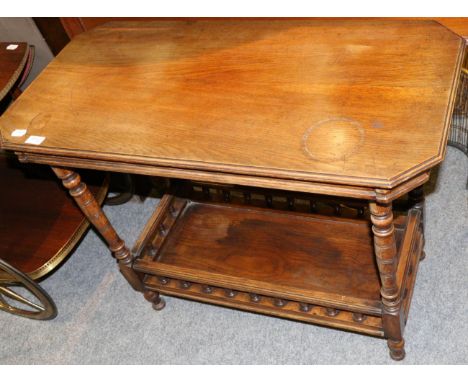 A late 19th century walnut two-tier table of octagonal shaped form, raised on turned legs joined with a shelf with a balustra