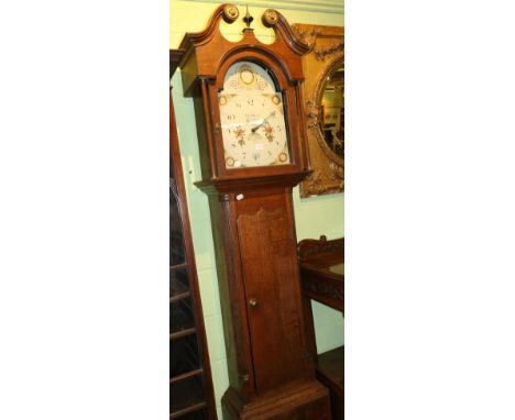 An early 19th century oak cased longcase clock, the painted arch dial with thirty hour movement, signed George Baird of Carli