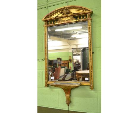 A Regency gilt and gesso wall mirror, early 19th century, the architectural pediment above an urn joined by flowerbells with 