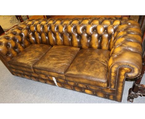 A modern buttoned brown leather Chesterfield sofa bed 