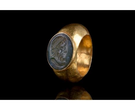 Ca. 100-300 AD. The ring features a round hoop with expanded shoulders, and an oval bezel, set with a carved intaglio with a 