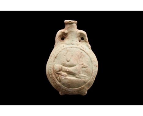 Ca. 660-525 BC. An acient Egyptian New Year's glazed composition flask decorated on one side with a rosette and the other wit