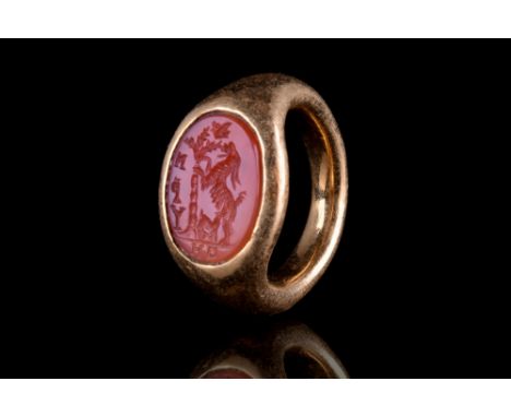 Ca. 100-300 AD. The ring features a round hoop with expanded shoulders, and an oval bezel set with a carved intaglio with a g