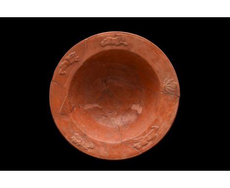 Ca. 1-300 AD. A lovely terra sigillata small bowl sitting upon a ring foot, from which the body flares to a wide rim with bar