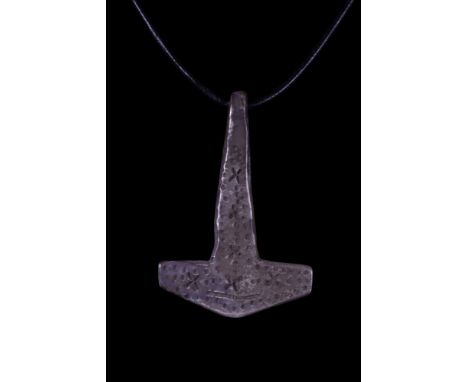 Ca. 900-1100 AD. A stunning silver pendant in the shape of a Mjölnir (Thor's hammer) decorated with engraved dots and crosses