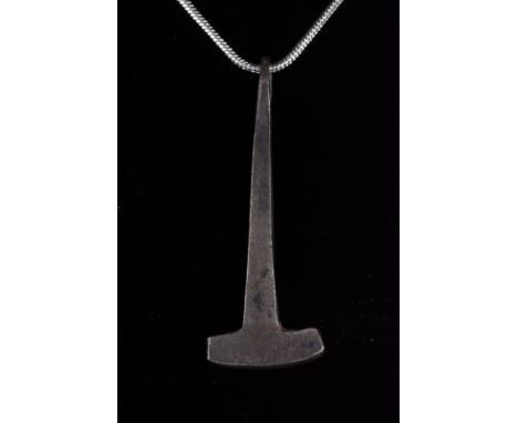 Viking Age, Ca. 700–900 AD. A silver amulet of a stylised hammer with a slightly asymmetrical head and a tapering shaft. This