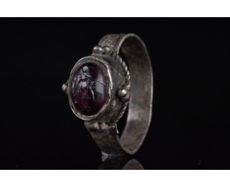 Ca. 300 AD. A beautiful silver ring with a circular band decorated with a central band of X-shaped motifs, flanked by two par