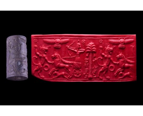 Ca. 8th-7th century BC or later. A grey stone cylinder seal from the Neo-Assyrian period. It depicts a charioteer shooting at