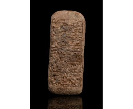Ca. 1900 BC. A rectangular-section ceramic tablet with rounded edges and corners, bearing cuneiform script to both faces in p