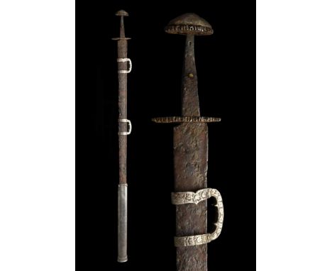 Ca. 900-1000 AD. A hand-forged Viking iron sword with Brazil nut pommel and decorated guard; the blade is wide at the upper e