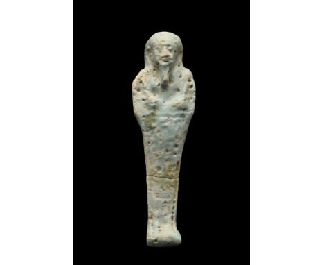 Late Period, 30th Dynasty, Ca. 332 BC. A mummiform figure in the form of an ushabti, moulded in a light-blue, glazed faience,