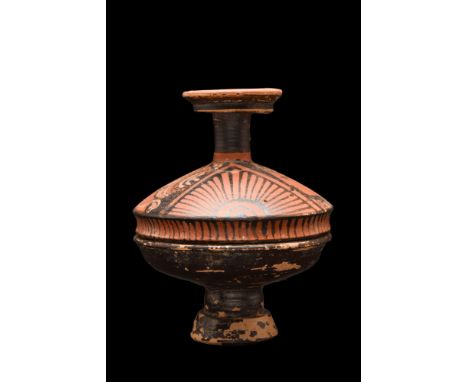 Ca. 340-325 BC. A ceramic lekanis of the red-figure lid with two female profile heads between palmettes and stylised volutes.