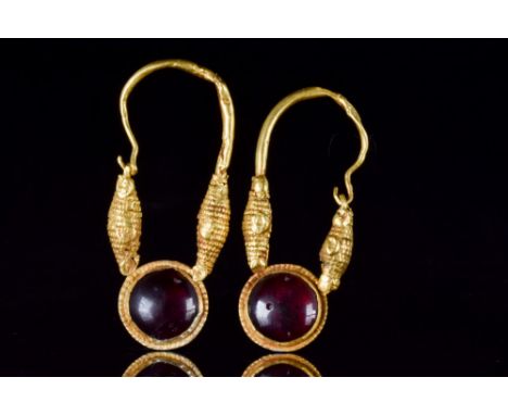 Ca. 300-100 BC. A matched pair of gold earrings, each of a hoop thickening to intricately decorated spindle-shaped terminals 