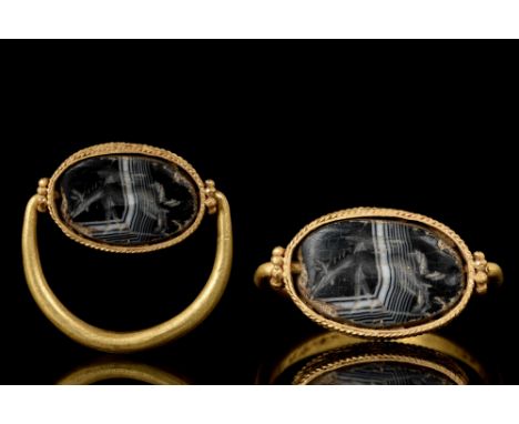 Ca. 400 BC. A finely modelled Ancient Greco-Phoenician swivel ring featuring an onyx intaglio with winged horse Pegasus set i