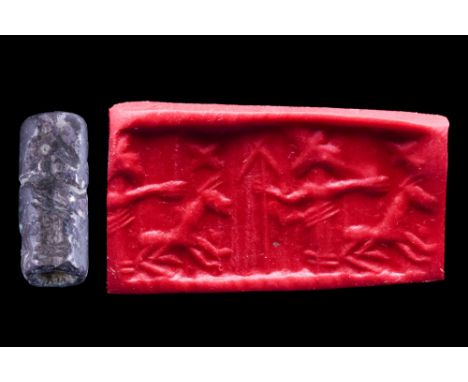 Ca. 1500-1000 BC. A nice Levantine black stone cylinder seal from the second half of the second millennium BC. It depicts a d