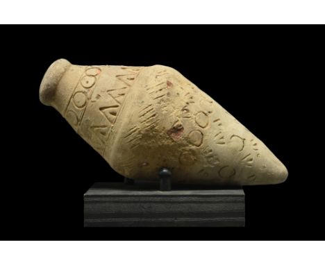 Ca. 900-1100 AD. A cream-coloured "Greek fire" hand grenade comprising a domed lid and a biconical body decorated with linear