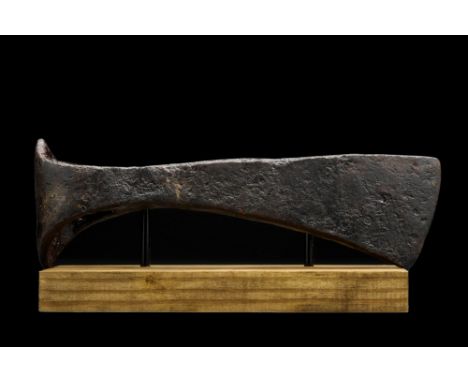 Ca. 900-100 AD. An iron axe head comprising a short, curved blade, elongated cheek, lozenge-shaped poll and round socket. Fai