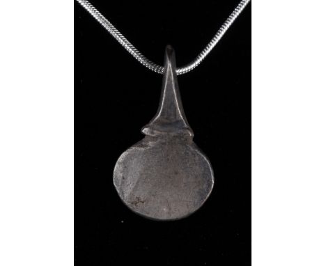 Viking Age, Ca. 900–1100 AD. A beautiful, solid silver pendant shaped as broad battle axe with an integral loop. This type of