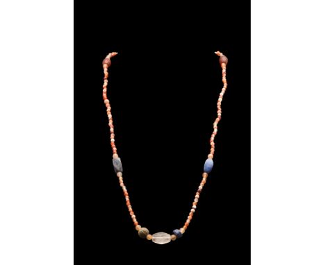 Ca. 2nd-1st millennium BC. A restrung necklace comprising of spherical-shaped beads, interspersed with large tubular beads. T