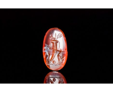 Ca. 100-200 AD. An oval-shaped carnelian intaglio, skilfully engraved with a cornucopia to the centre with a satyr to the lef