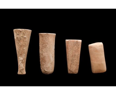 Ca. 3000 BC. A group of four alabaster votive vessels, each of cylindrical form with drilled interior. The vessels are made o