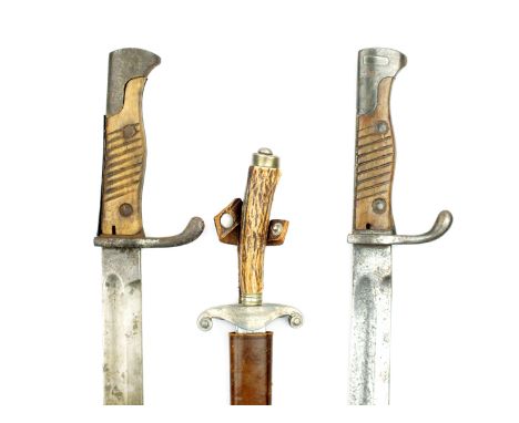 Two First War period German Mauser bayonets, lacking scabbards, together with a German fighting knife with flattened diamond 