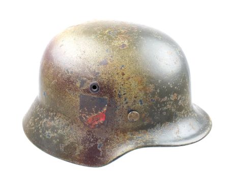 A Second War period Third Reich “Normandy” camouflage M40 single decal helmet, the steel skull with turned rim, painted over 