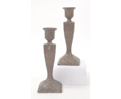 A pair of early 20th century French Chinese manner candle stick holders. Circular candle holder top, into a square tapering b