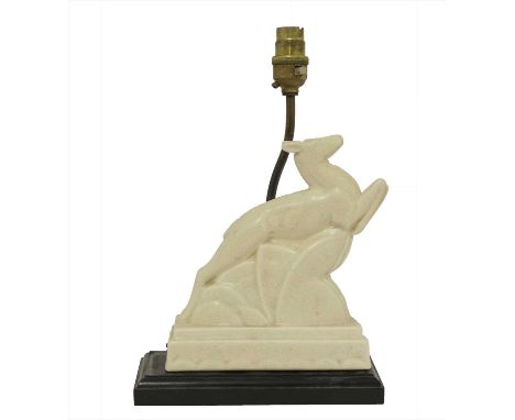A French Art Deco moulded antelope, on an ebonised plinth with lamp, impressed square mark indistinct, 19.5cm high 31cm high 