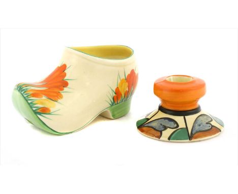 A Clarice Cliff 'Bizarre' dwarf candlestick , decorated with blue, brown and green leaf tips and an orange sconce, 8.5cm diam