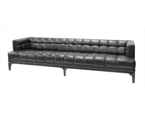 A black leather button-upholstered settee, c.1960, by Maurice Bailey for Monteverdi-Young, raised on faceted walnut legs and,