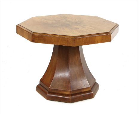 An Art Deco octagonal walnut lamp table, raised on a low column, 59cm diameter 45cm high