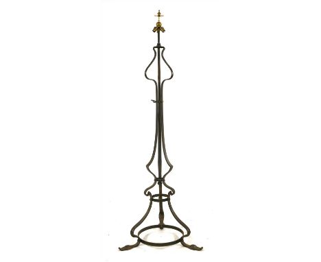An Arts &amp; Crafts wrought iron standard lamp, attributed to the Birmingham Guild, with an extendable shaft and three light