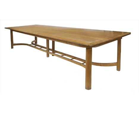 An oak refectory table, with a chamfered top, raised on oval legs united with a hayrake and ladder-type supports, 366cm long 