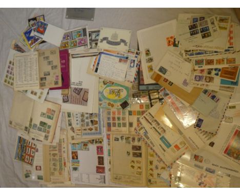 A box containing various World stamps on leaves, albums of mixed stamps, covers, first day covers etc.