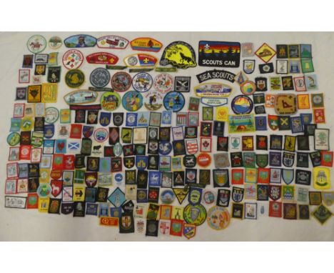 A large selection of various Boy Scout and Girl Guide cloth badges and insignia, Outdoor Hints for Boy Scouts book, Girl Guid