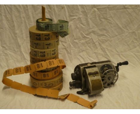 A bus conductor's ticket machine together with numerous unissued rolls of tickets