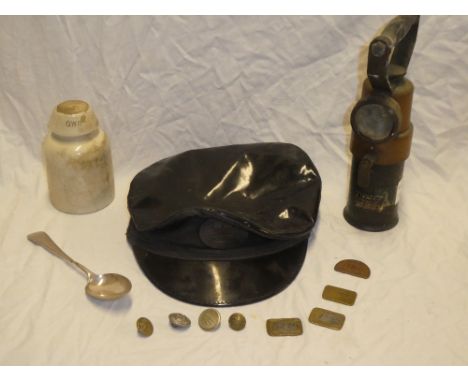 A selection of GWR railway memorabilia including porcelain insulator GWR pay checks, buttons, copy GWR engine driver's cap, s