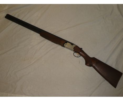 A virtually new Beretta 12-bore o/u Model 5686 multi choke shotgun No. 94765 with 28" barrels, engraved action and chequered 