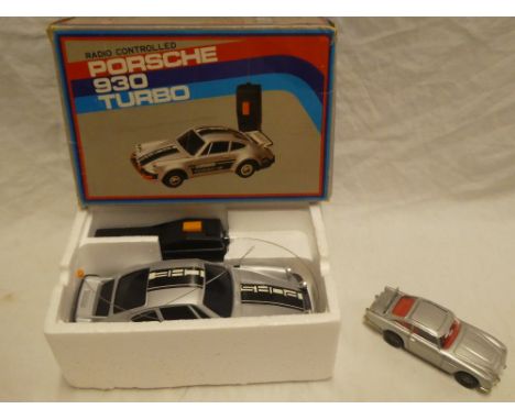 A Corgi 007 Aston Martin DB5 and a boxed radio controlled Porsche 930 Turbo