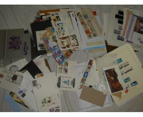 A large selection of various first day covers, stamps on album pages, and mixed World stamps etc.