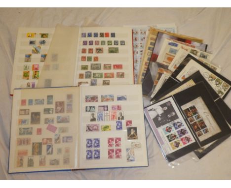 Two stock books of Commonwealth and World stamps together with a selection of first day covers, stamp smiler sheets, mint sta