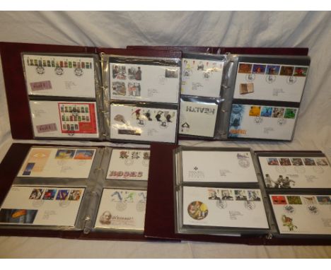 Four folder albums containing a large collection of GB first day covers, 1990's onwards