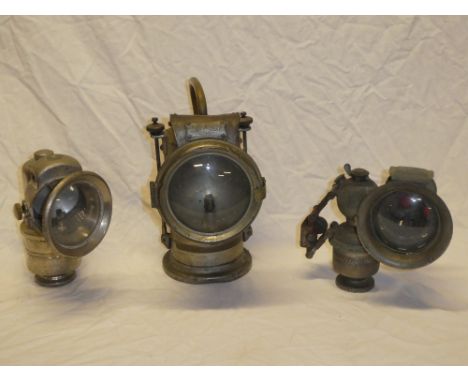 Three various carbide motoring lamps including Lucas "King of the Road" carbide lamp, Regalite carbide lamp with side lens an