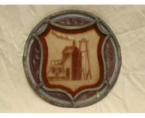 An old circular leaded coloured glass panel, the centre depicting a Cornish mining engine house, 8" diameter